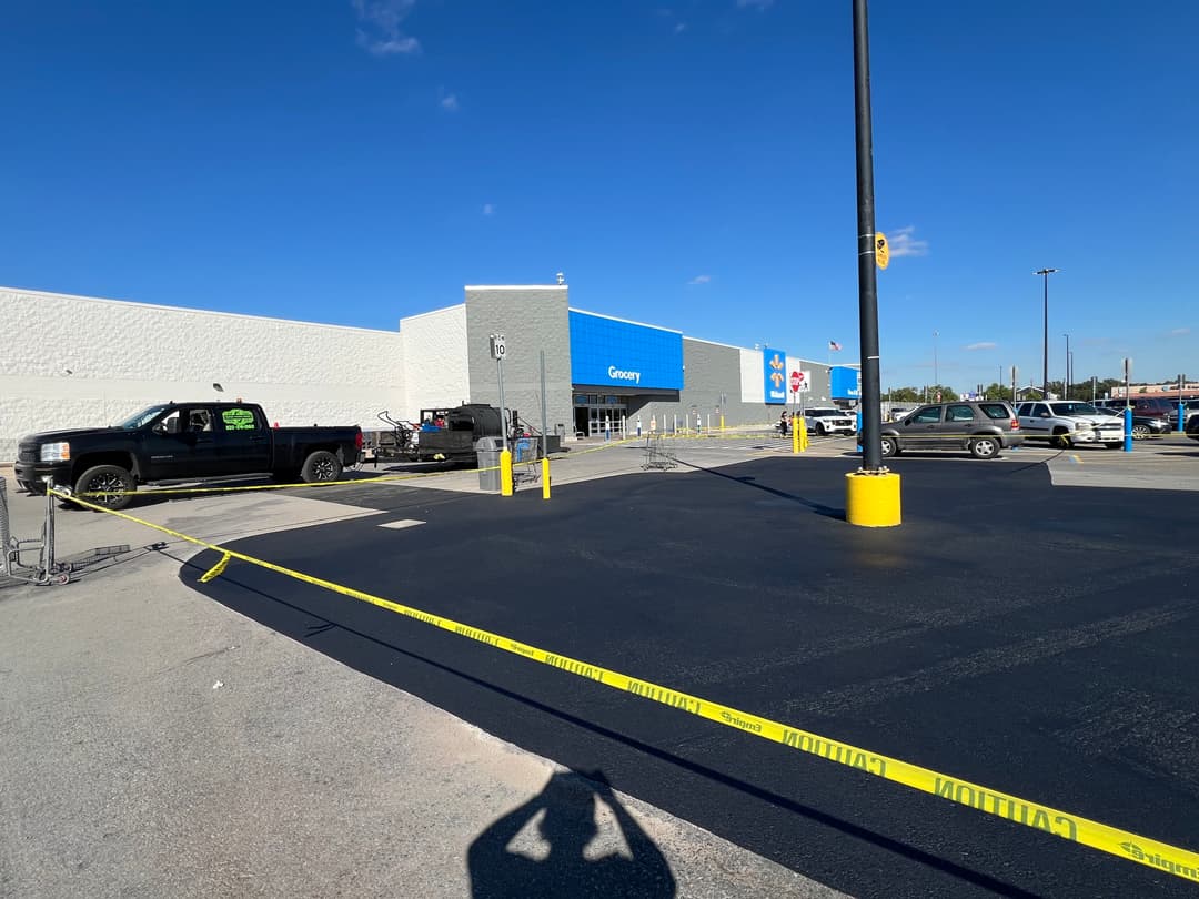 Walmart grocery entrance with construction barriers and vehicles in the parking lot.