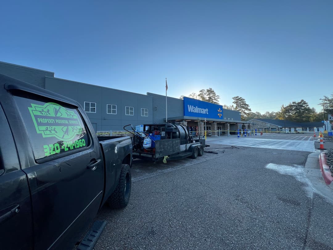 Walmart storefront with truck and trailer in front, early morning scene.
